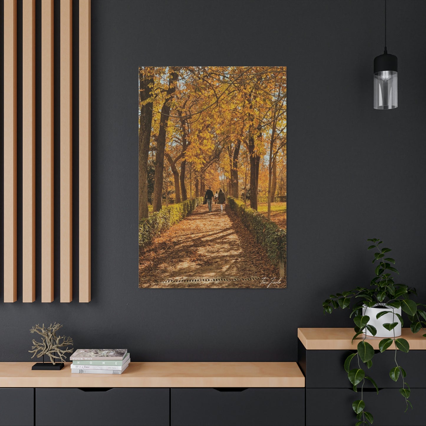 Our fall wall art in Spain is very colorful and vibrant. A couple is walking on the park trail with other families in front, the bright yellow leaves surrounding them. This canvas is a size 32 x 48. 
